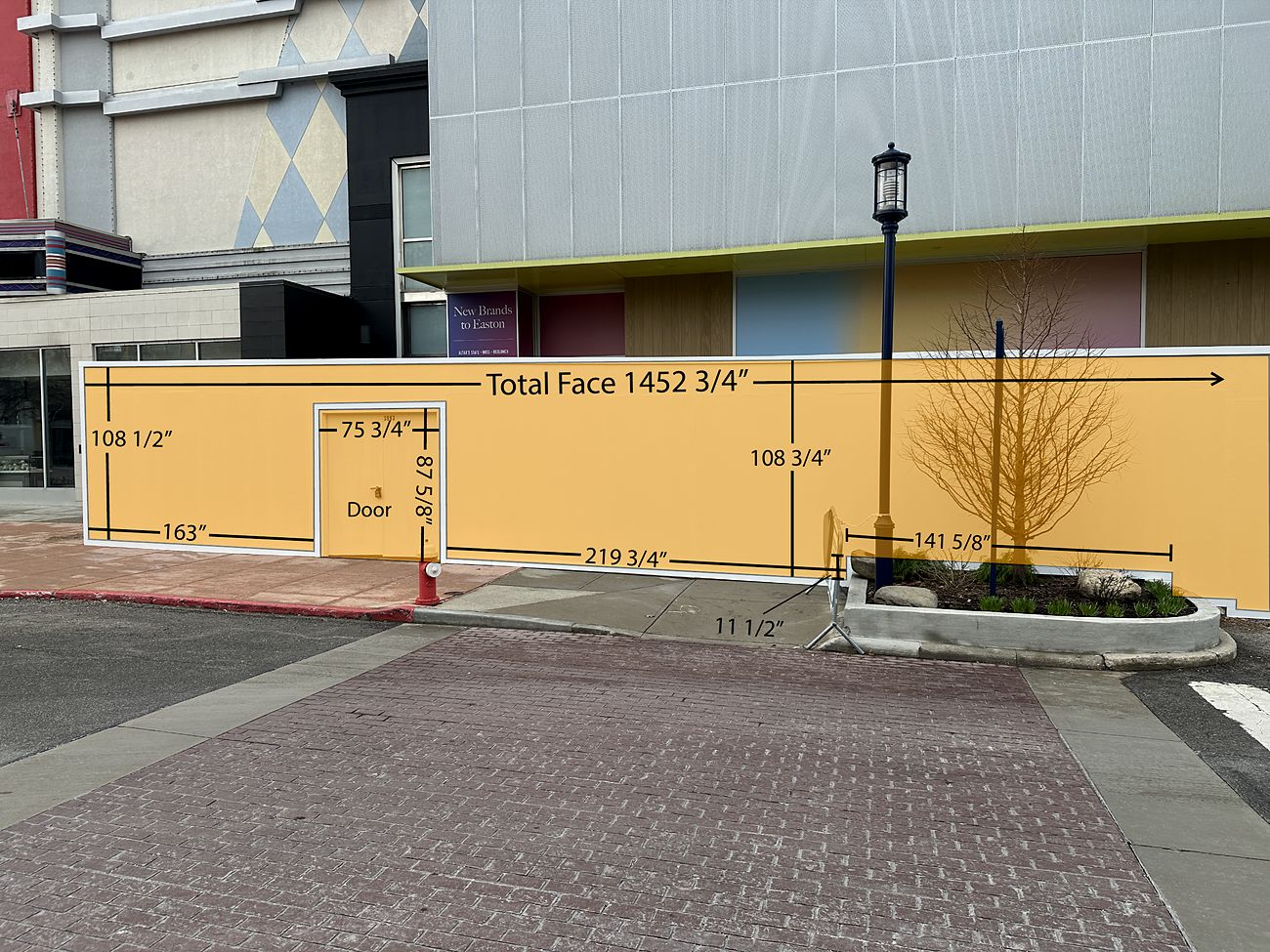 Survey drawing of a retail barricade face with every dimension measured and annotated over a site photograph